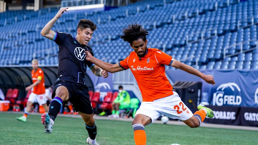 July 4, 2021. Forge FC vs. Pacific FC. Second-Half. Monti Mohsen of Forge FC plays the ball away from a defending Kadin Chung of Pacific FC