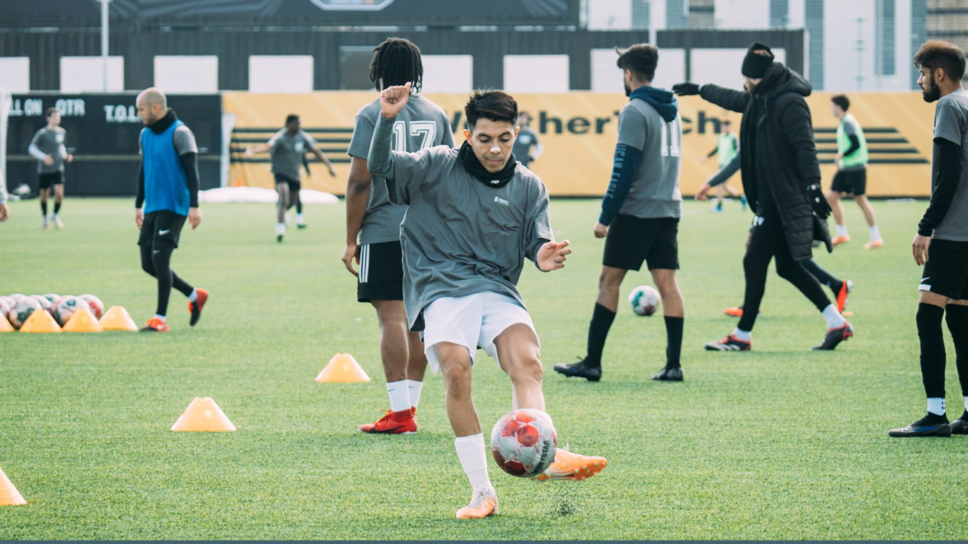 Student kicking soccer ball