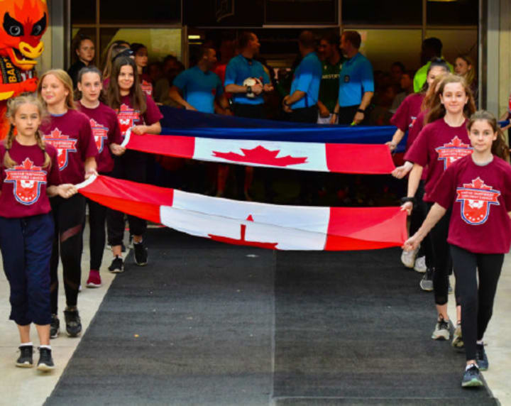 Kids carrying flag out to field