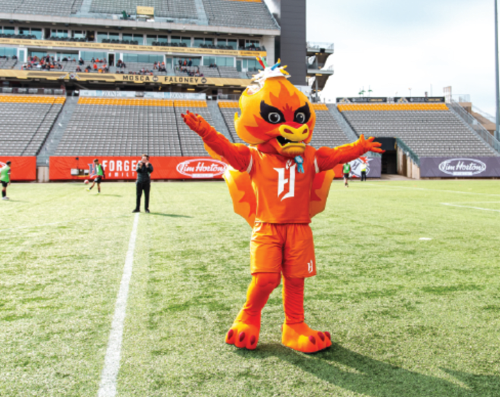 Forge FC Mascot on the field cheering