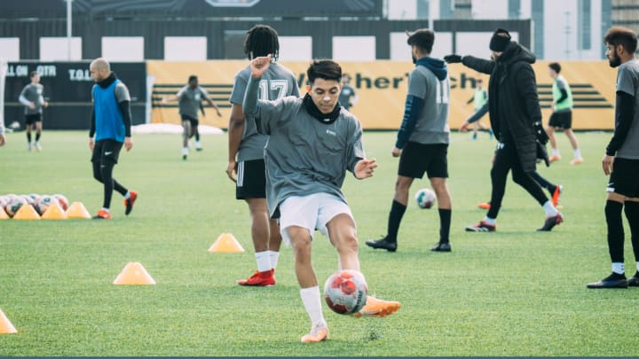 Student kicking soccer ball